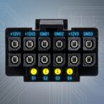 Close-up view of a 12VHPWR connector with labeled pin configuration and color codes