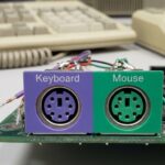 Close-up of PS/2 ports on a motherboard illustrating color coding