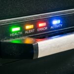 Close-up of NAS drive tray with colored status lights