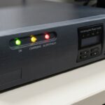 UPS unit with green, yellow, and red LED indicators showing various statuses