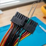 Close-up of PSU connector with green and black wires highlighted