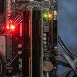 Close-up of motherboard with red error light and labeled components